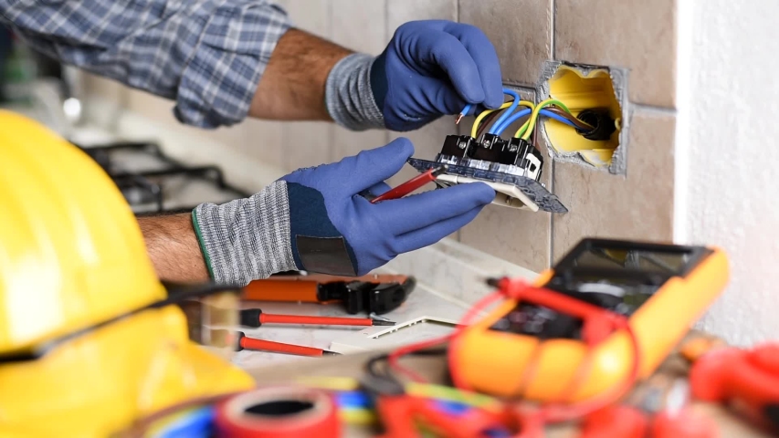 Electrician at work with screwdriver fixes the cable in the sockets of a residential electrical system. Construction industry. Footage. Royalty-Free Stock Footage #1058327926