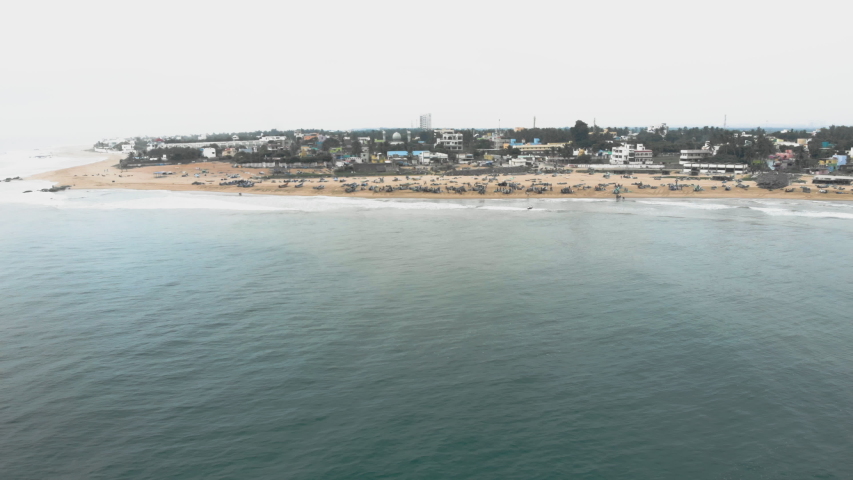 4k Drone footage of busy fishing village with incoming boats in Tamil Nadu, India
