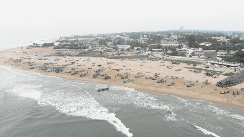 4k Drone footage of busy fishing village with incoming boats in Tamil Nadu, India