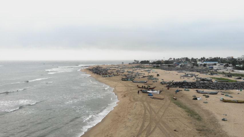4k Drone footage of busy fishing village with incoming boats in Tamil Nadu, India