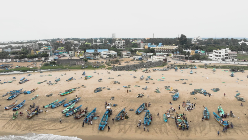 4k Drone footage of busy fishing village with incoming boats in Tamil Nadu, India