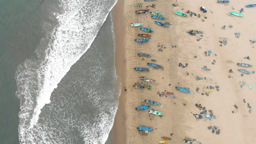 4k Drone footage of busy fishing village with incoming boats in Tamil Nadu, India