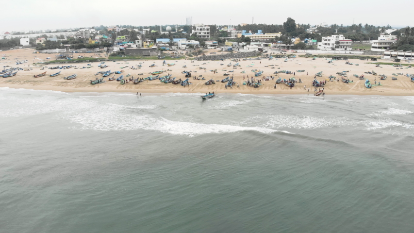 4k Drone footage of busy fishing village with incoming boats in Tamil Nadu, India