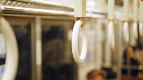 Close Up Of Train Handles Swaying In Japanese Subway. 4K Transport Concept Slow Motion Footage. Japan.