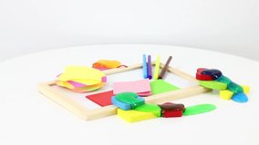 Different office supplies and consumables on white rolling table background.