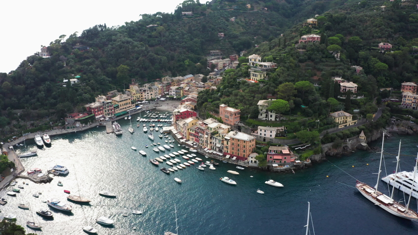 Aerial shot of famous picturesque harbour Portofino with luxurious Yachts, Genoa, Italy, Europe, sunny summer day Royalty-Free Stock Footage #1058335312