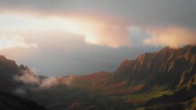 Aerial video from the clouds over a magnificent valley between beautiful green slopes in Waimea Canyon, Kauai, Hawaii