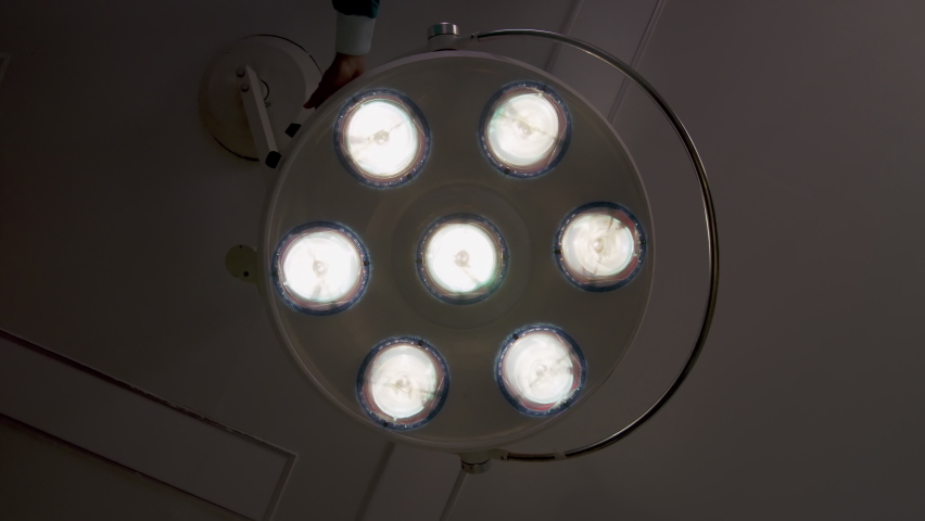 POV view from patient on bed looking opening light equipment on ceiling wall in operating room.