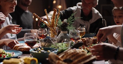 Happy members of large caucasian family toasting to a wish, clinking their glasses during christmas family gathering and dinner xmas party - real people, celebration concept 4k footage