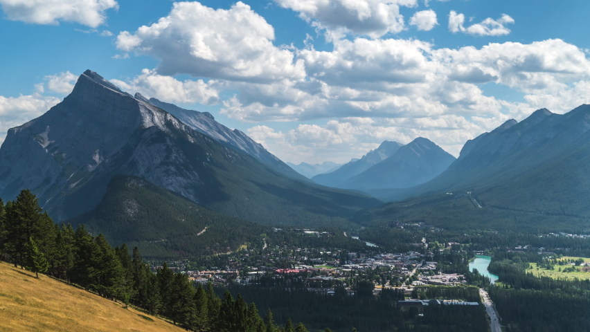 Banff National Park, Alberta, Canada, daytime time lapse view of Banff village and Mount Rundle during summer, zoom out. 