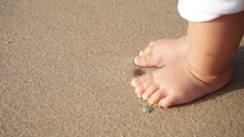 Close up baby feet on the beach