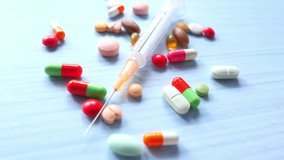 syringe and pills on white background, close up  - Powered by Shutterstock - Get 15% off with code: PIKWIZARD15