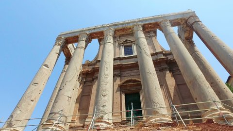 Roman forum in Rome with tilt shot of columns at San Lorenzo Miranda in spring sunny day with blue sky