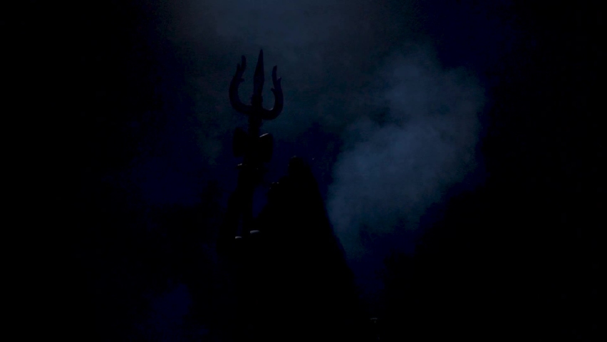 Mahadev, Lord Shiva Silhouette sitting Posture with Trishul in Hand Indian Hindu God Royalty-Free Stock Footage #1058356978