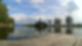 Blurred background. Fast video timelapse landscape pier river sky clouds trees summer