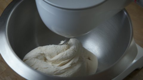 Dough in home processor. A view of a working home dough machine in the kitchen.