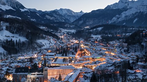 Day to night aerial hyper lapse old town Berchtesgaden covered by winter snow, Bavaria, Germany.
