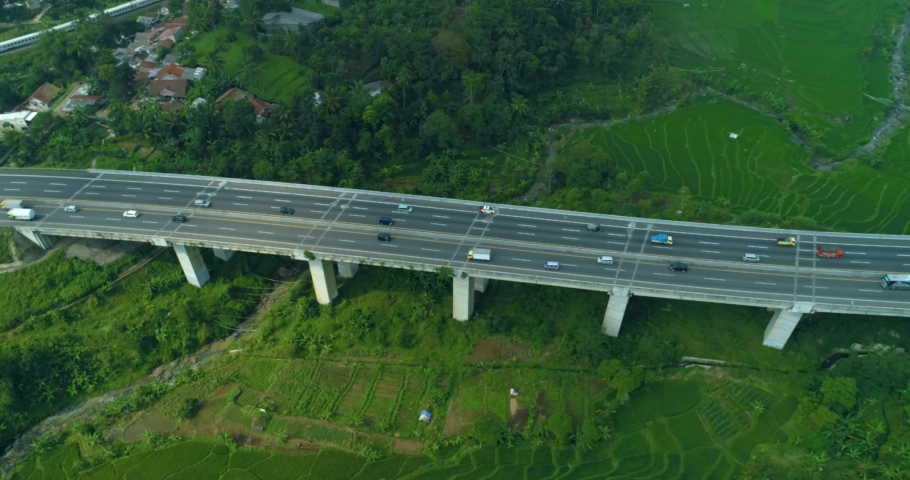 Scenic aerial view of a cimeta bridge cipularang toll road and green rice  field, bandung, west java indonesia