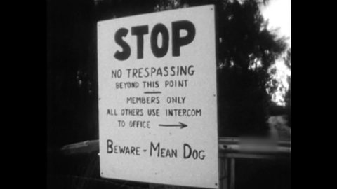 CIRCA 1960s - Roads to a nudist retreat have signs and intercoms leading drivers to the spot.