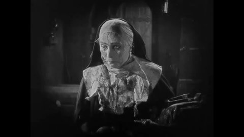 CIRCA 1922 - In this horror film, a medieval nun covered in blood who'd been possessed by the devil takes a statue of Christ out of Mary's arms.
