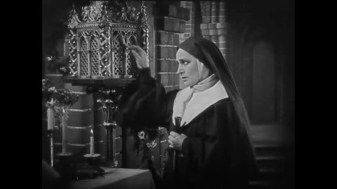 CIRCA 1922 - In this classic horror film, the devil possess a medieval nun at the altar of a church, frightening the other nuns in the convent.