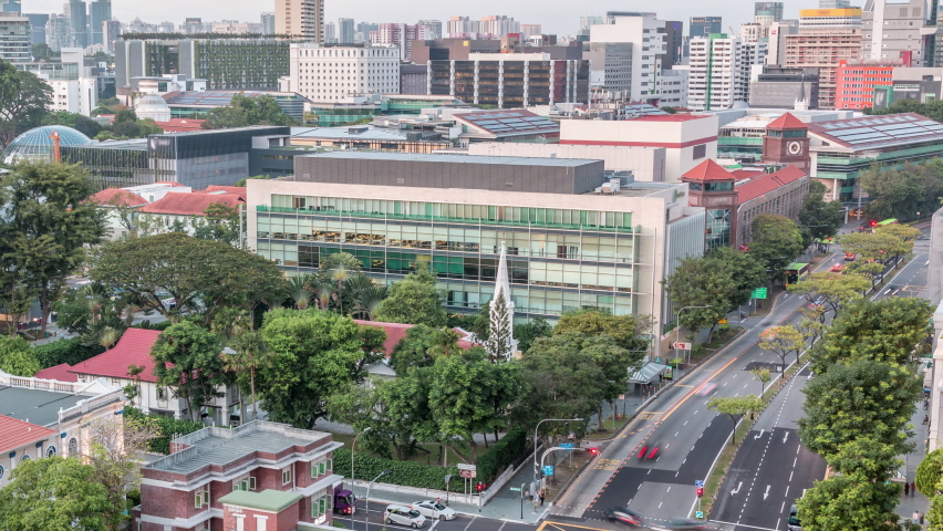 Street traffic on intersection near the fire station and skyline of Singapore day to night transition aerial timelapse. The Central Fire Station is the oldest existing fire station in Singapore on