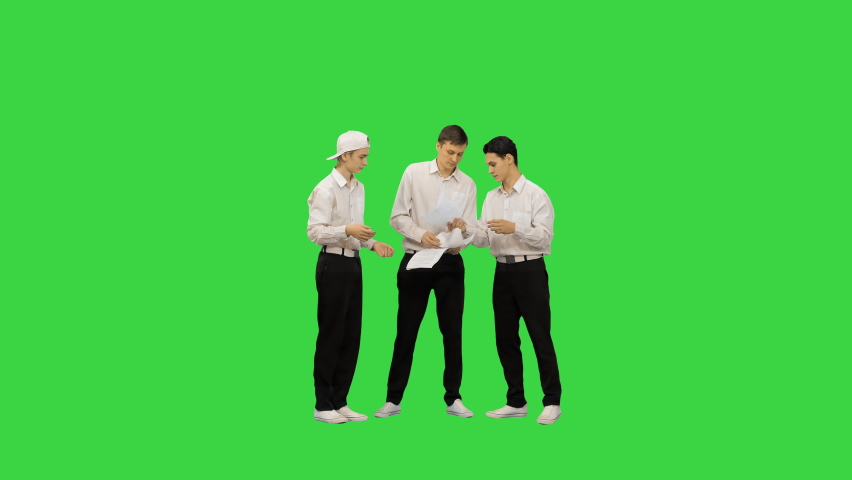 Three guys throwing documents in the air and starting to dance in a funny way on a Green Screen, Chroma Key. | Shutterstock HD Video #1058383084