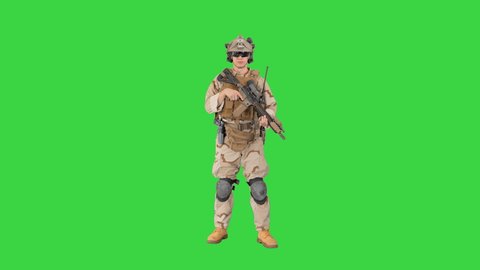 Soldier shooting with assault rifle and reloading on a Green Screen, Chroma Key.