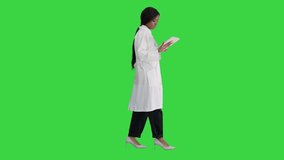 African American female doctor holding a tablet computer while walking on a Green Screen, Chroma Key. - Powered by Shutterstock - Get 15% off with code: PIKWIZARD15