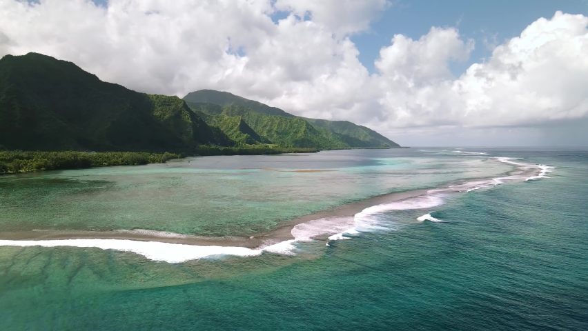 Drone Tahiti, 4k. Surf wave. Exotic tropical island, ocean lagoon, mountains. Aerial view of French Polynesia. Teahupoo is a famous surfing destination near Papeete. Adventure travel.  Royalty-Free Stock Footage #1058387023