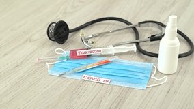 Medical mask with vaccine and syringe protecting from coronavirus with thermometer isolated on wooden background.