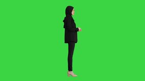 Confident young muslim business woman wear hijab speaking to camera on a Green Screen, Chroma Key.