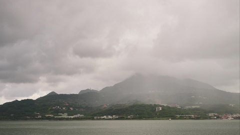 Time lapse of rain clouds passing over a mountain near Tamsui
