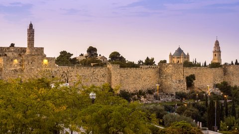 Beautiful sunrise view of the Old City wall of Jerusalem, from the mamluk minaret of the Jerusalem Citadel to the Dormition Abbey on Mount Zion, with its lead-covered basilica and a bell tower