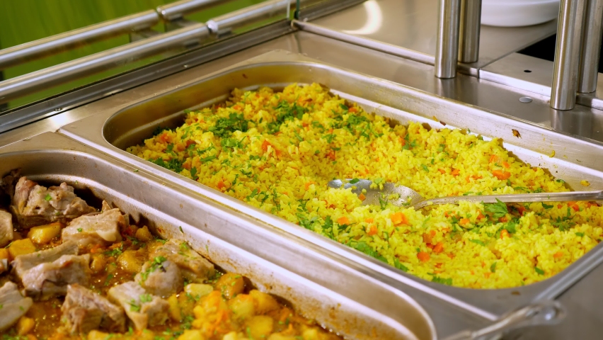 Close-up. display showcase with freshly prepared meals in self-service cafeteria or buffet restaurant. health food. volunteering and charity. reopening . safety concept | Shutterstock HD Video #1058409376
