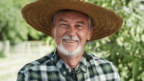 Close up video portrait of happy farmer in a hat. Shot with RED helium camera in 8K.