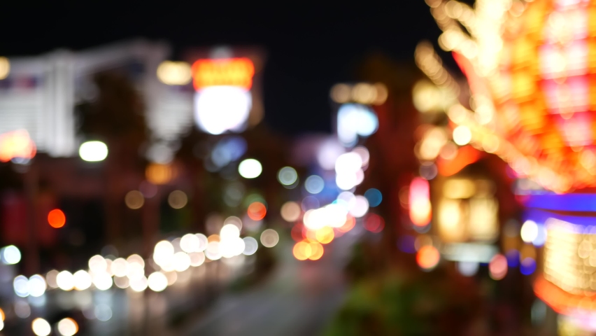Defocused fabulous Las Vegas Strip boulevard, luxury casino and hotel, gambling area in Nevada, USA. Nightlife and traffic near Fremont street in tourist money playing resort. Neon lights of sin city.
