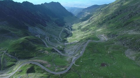 Beautiful aerial view of Romanian Transfagarasan Road crosssing the Carpahtian Mountains, breathtaking landscape over the hairpins of the national road, high altitude drone footage, mountains, valley.