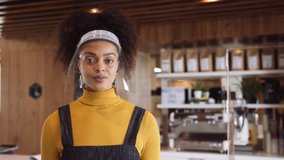 Medium Close up shot, Female African shop owner wearing face visor standing in shop small business - Powered by Shutterstock - Get 15% off with code: PIKWIZARD15