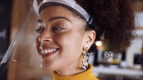 Close up eye level shot, Female African shop owner wearing face visor standing in shop small business during covid 19. - Powered by Shutterstock - Get 15% off with code: PIKWIZARD15