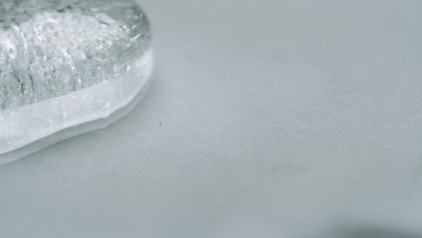 Clear Gel With Tiny Bubbles Flowing And Moving Smoothly On A White Surface. - macro shot | Shutterstock HD Video #1058420683