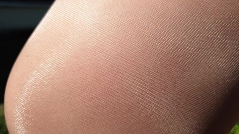 shiny thin beige tights, women's leg in nylon pantyhose