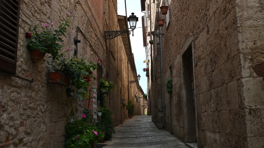Colle di Val d'Elsa, Tuscany, Italy. August 2020. POV film walking in the alleys of the historic center: enchanting glimpses of medieval times full of charm, you advance along the paving. Royalty-Free Stock Footage #1058424160