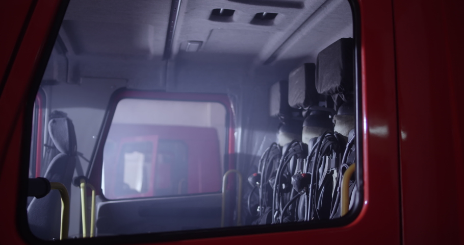 Group of professional firefighters climbing into fire engine and adjusting gear before riding on call Royalty-Free Stock Footage #1058424223