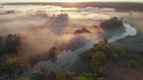 Aerial drone view of sunrise over misty river. Calmness, relaxation, meditation, solitude, beauty of nature concept - Powered by Shutterstock - Get 15% off with code: PIKWIZARD15
