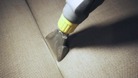 Close up footage of cleaning Sofa with vacuum cleaner and detergent, Before and after view