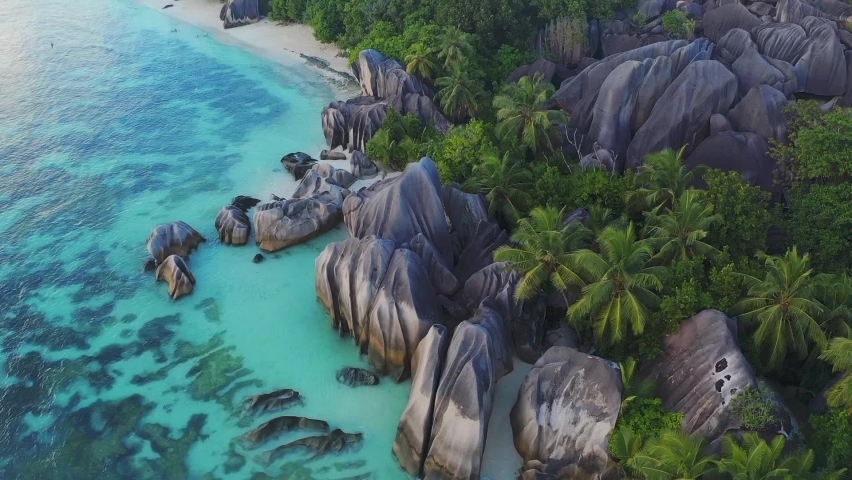 Aerial drone view on the beautiful white sand rocky beach in the seychelles, La digue silver bay Royalty-Free Stock Footage #1058428273