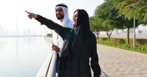 Happy couple spending time in Dubai. Young man and woman wearing uae traditional clothes