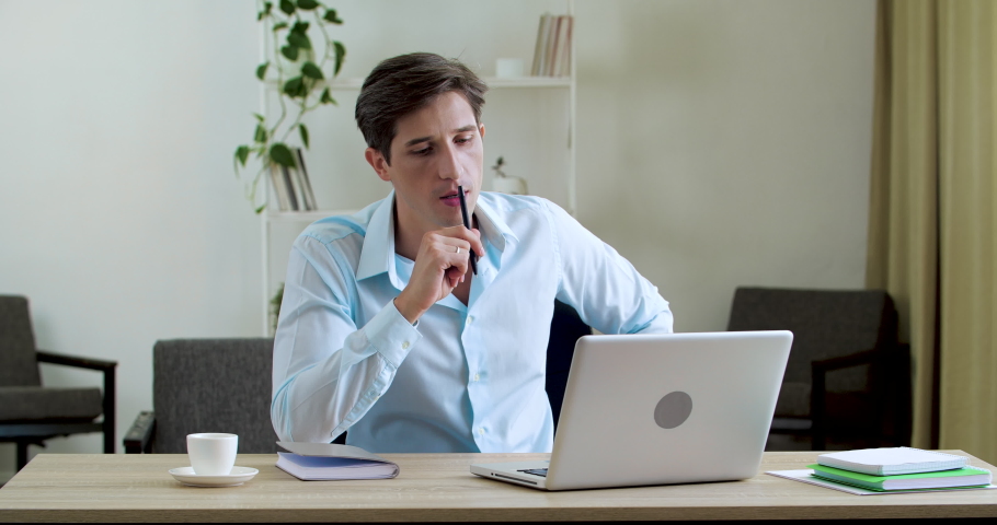 Male worker tired sitting in office without air conditioning ventilation problems, feeling irritated, exhausted from heat, suffering from high air temperature, picking up notebook waving creating wind Royalty-Free Stock Footage #1058432647