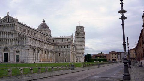 Pisa, Italia - 06/07/2020 Wide tracking shot of the Leaning Tower of Pisa, Cathedral in Piazza dei Miracoli, Italy, featuring the famous bell tower.  Square deserted due to the coronavirus pandemic